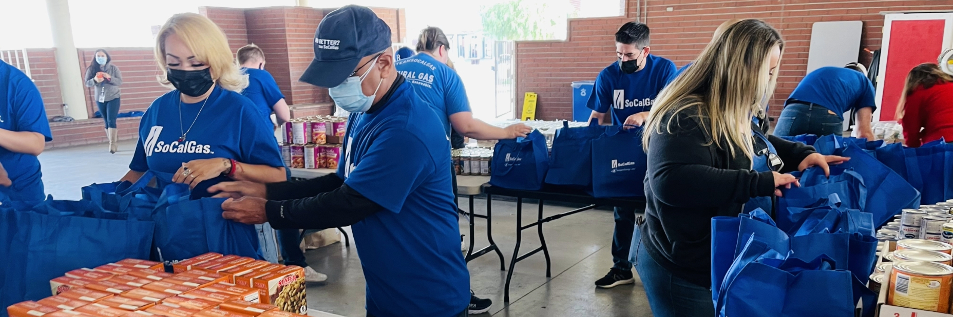 SoCalGas volunteers putting together bags with thanksgiving items