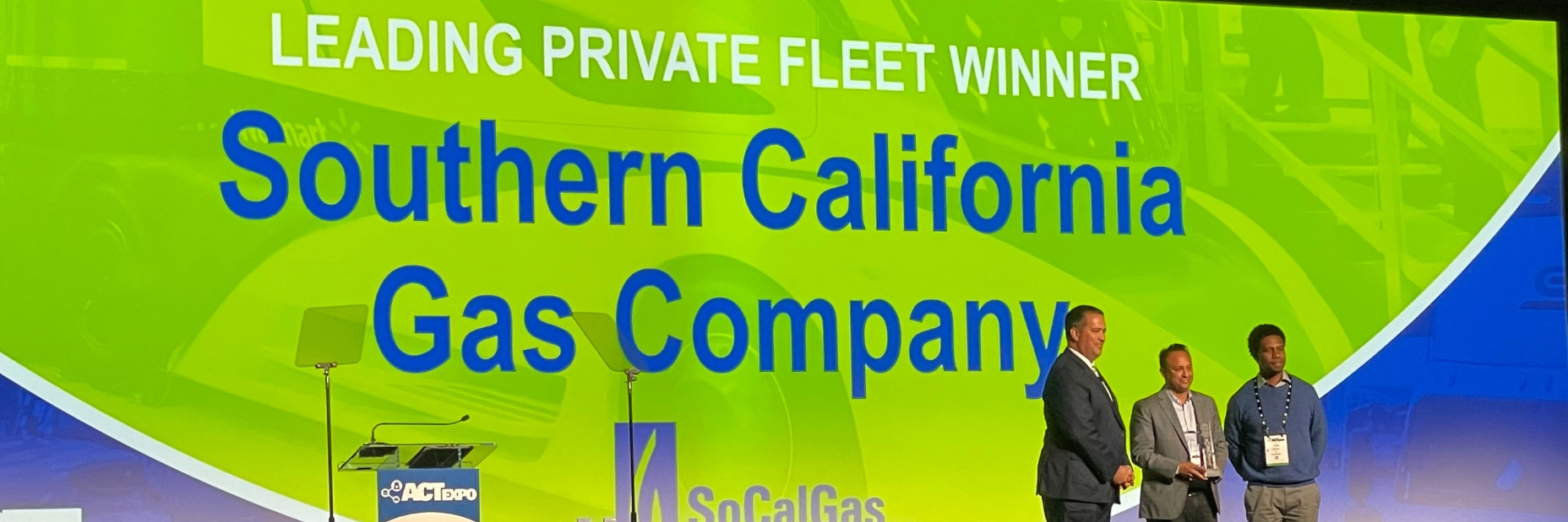 Socalgas executives accepting the award on stage