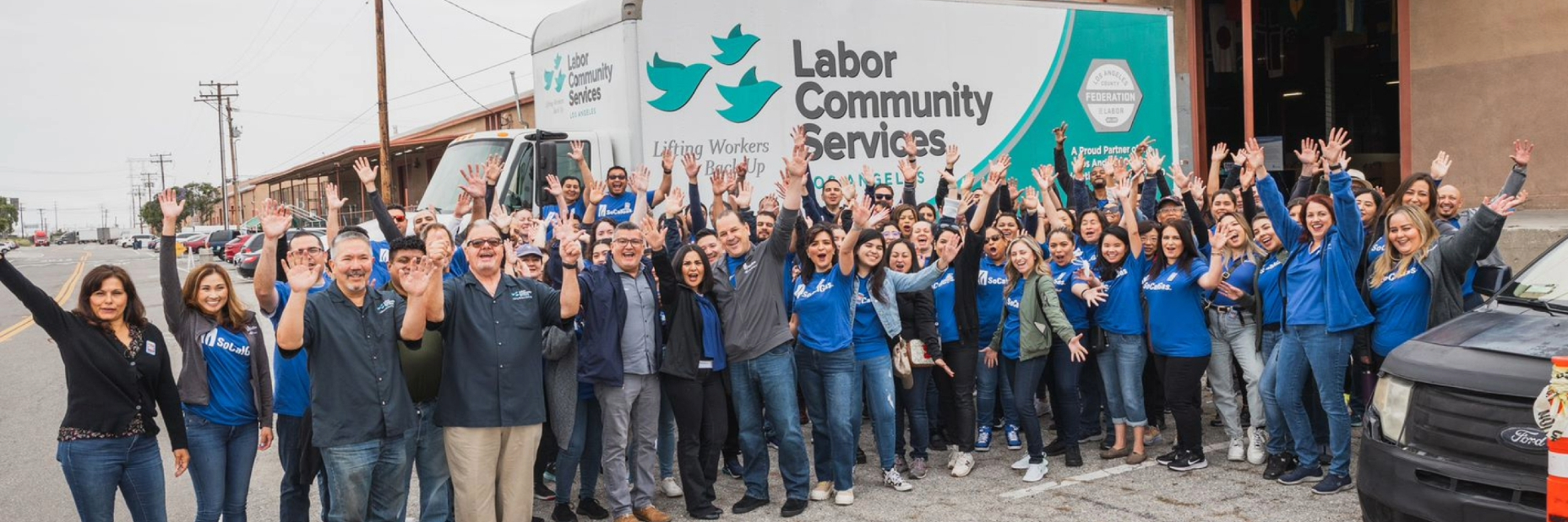 socalgas volunteers posing in front of labor community services truck at stamp out hunger event