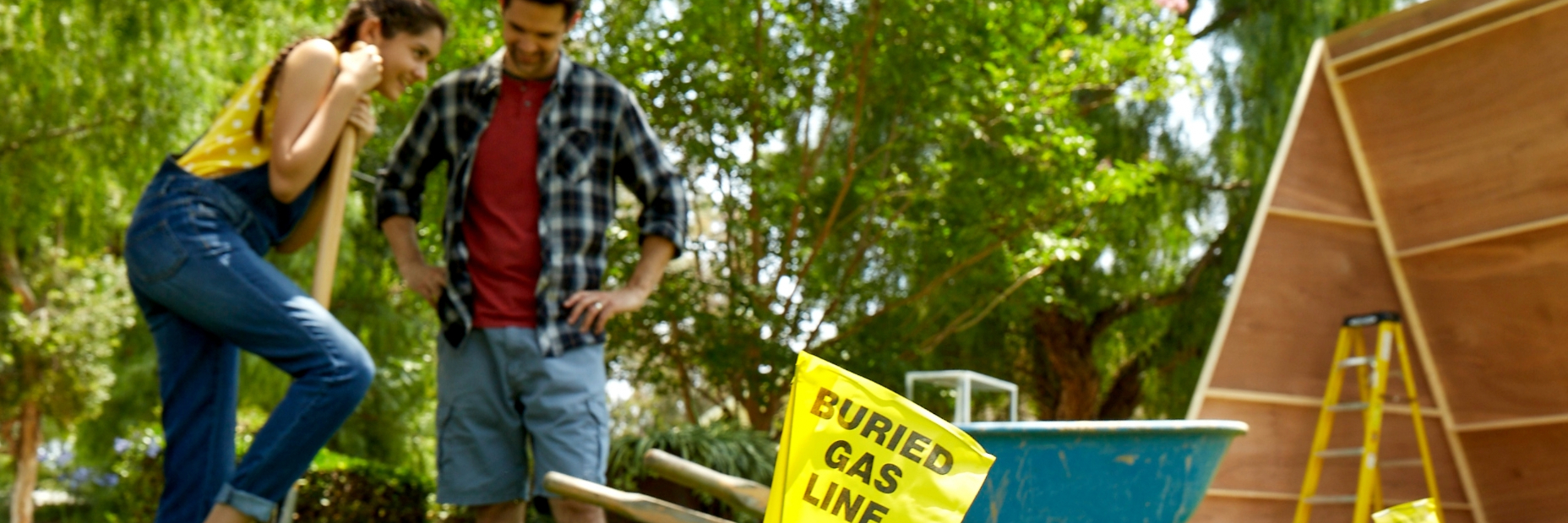 Man and woman digging with buried gas lines marked from calling 811