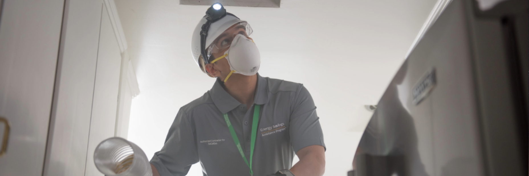 man on ladder checking air ducts