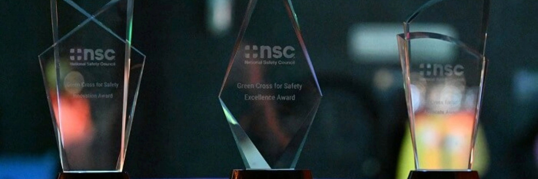 Image of three green cross awards on a table