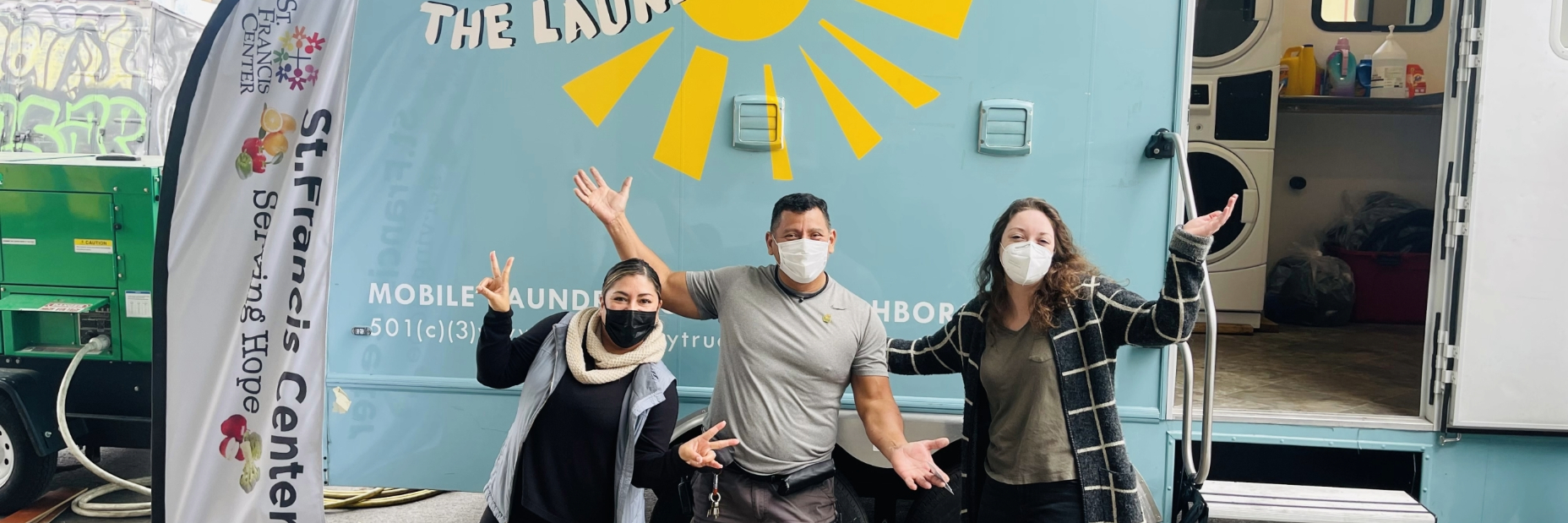 laundry truck la posing in front of their truck