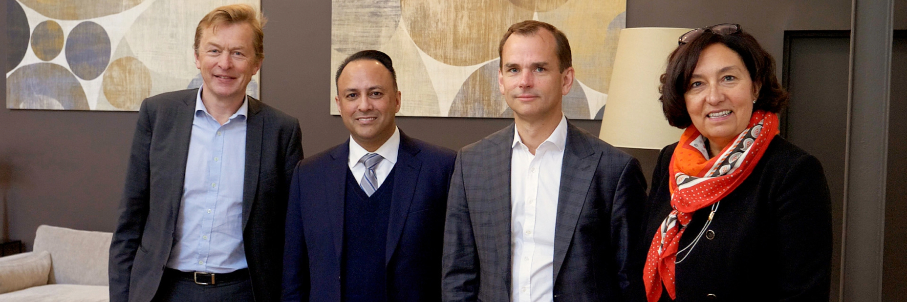 4 executives posing for a picture