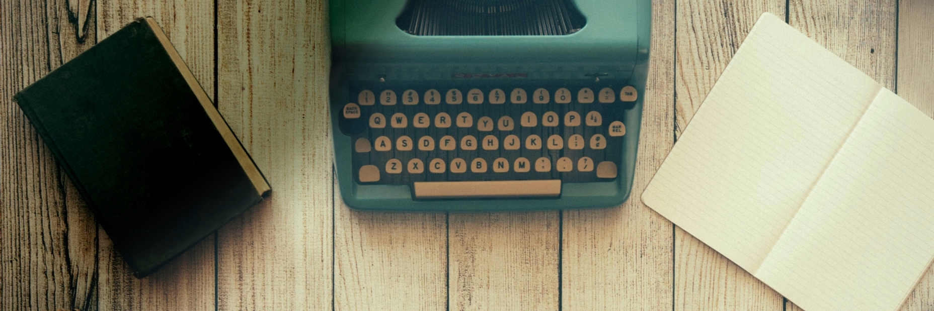 Generic Image with a typewriter and a notebook on a table