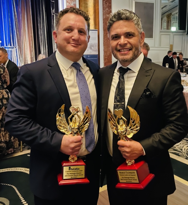 Marco and Devin holding the awards